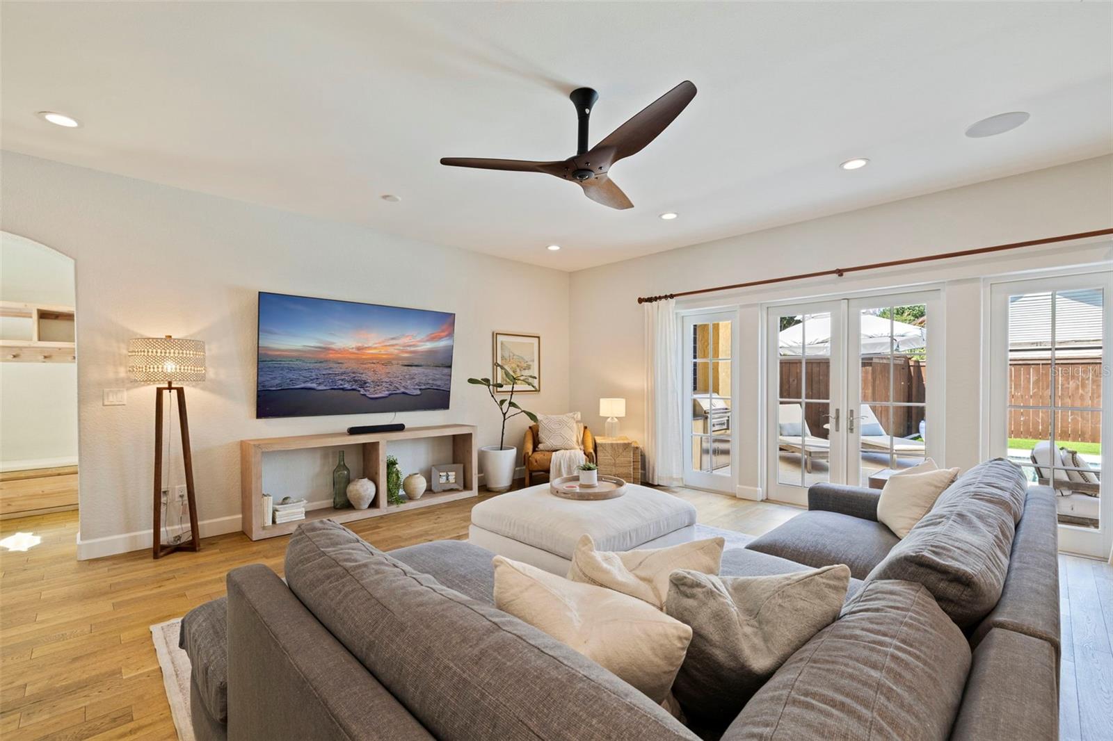 Open and spacious living room that opens up to the kitchen, courtyard, mud room and garage, and the backyard.