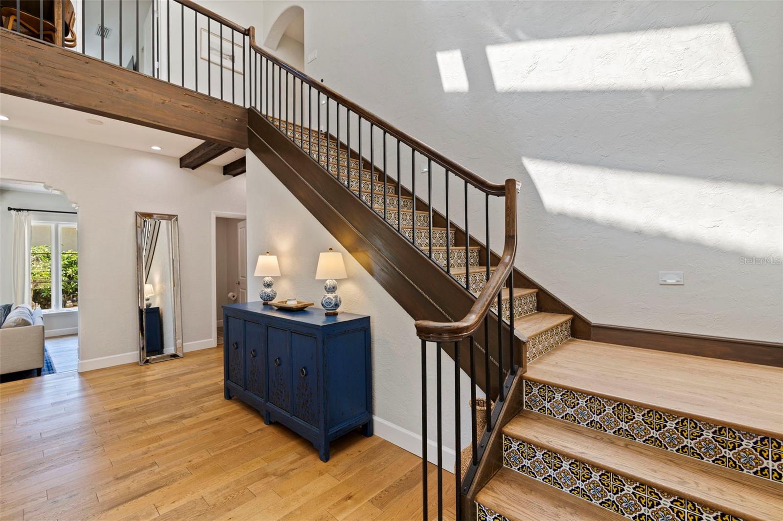 Grand stairs with the skylight reflecting on the wall.