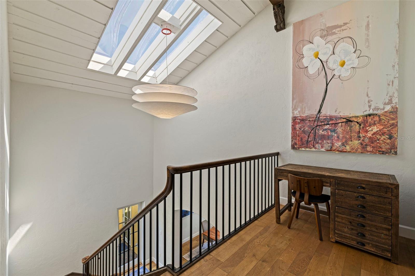 The skylight illuminates the stairwell and the large landing area with desk.
