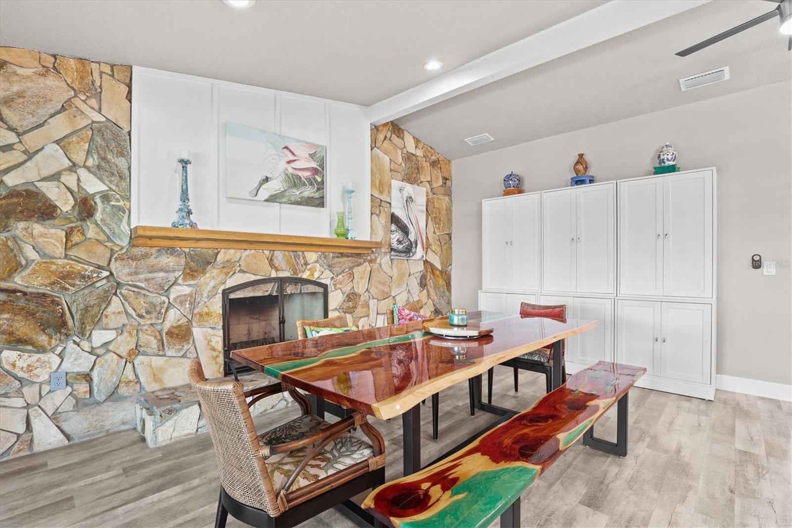 Dining Room with White Cabinets & Stone Fireplace