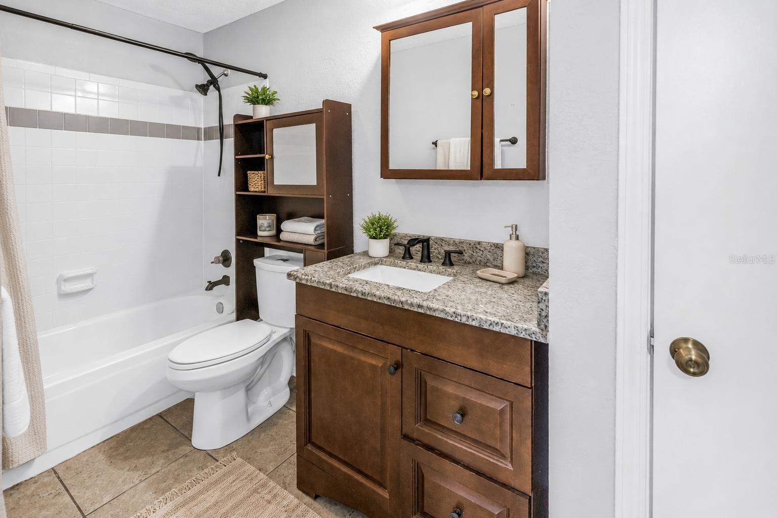 Updated Bathroom with Granite Vanity and Shower Tub Combo