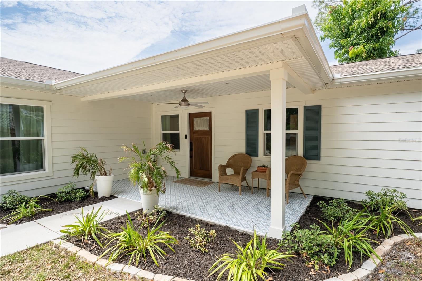Beautiful covered front porch with ceiling fan