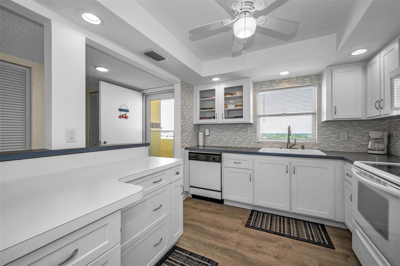 Open Kitchen with recess lighting, and wood cabinets