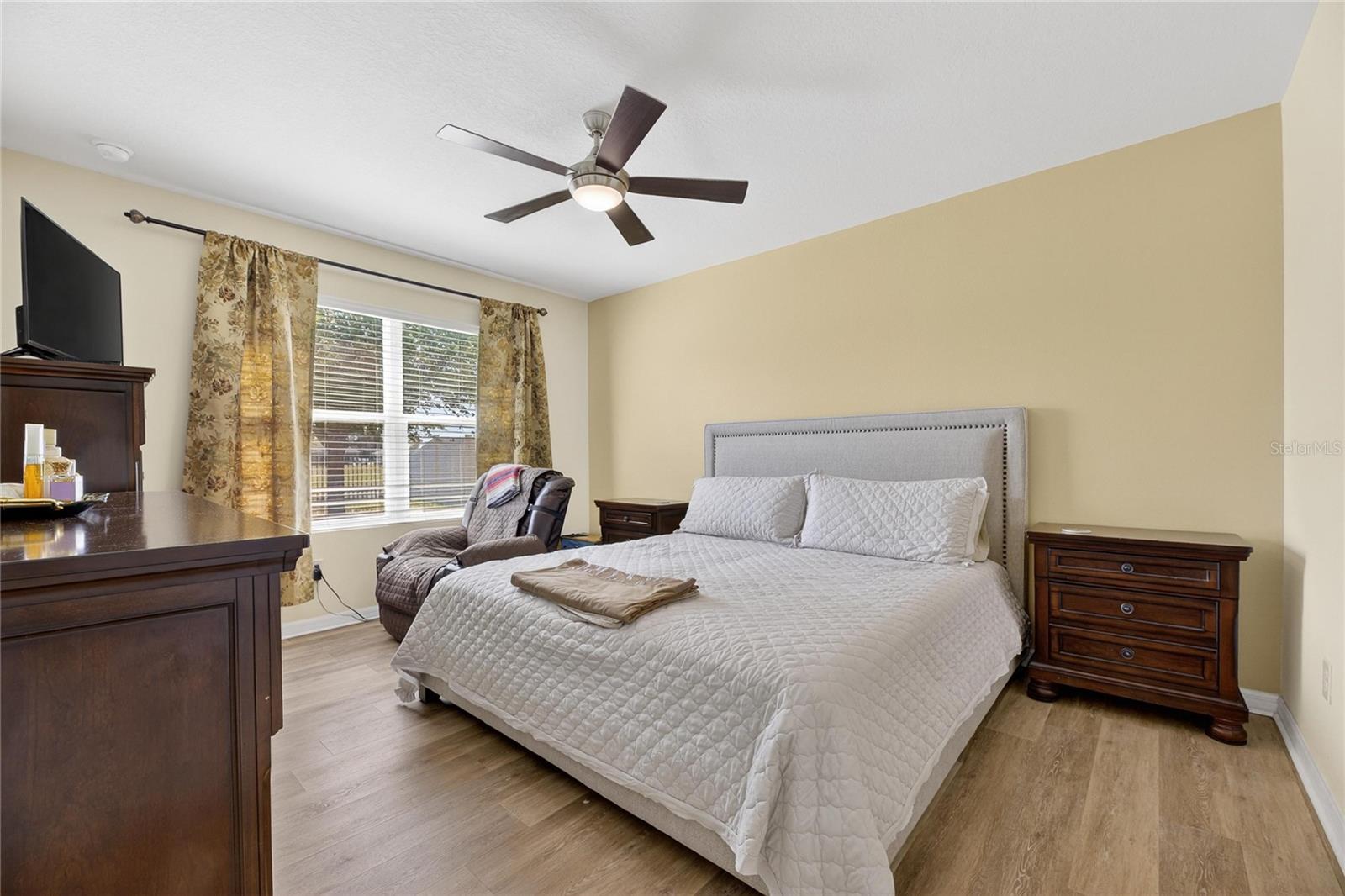 Roomy primary suite featuring new luxury vinyl flooring and relaxing views of the serene pond.