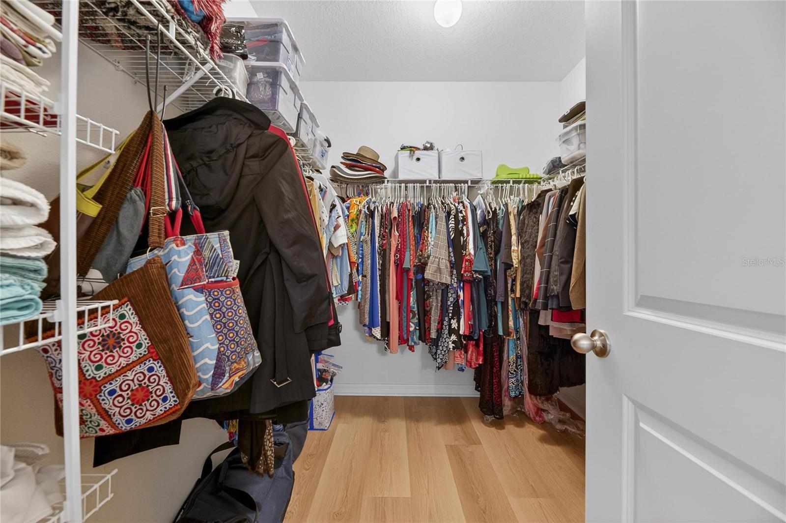 Large walk-in closet with luxury vinal flooring