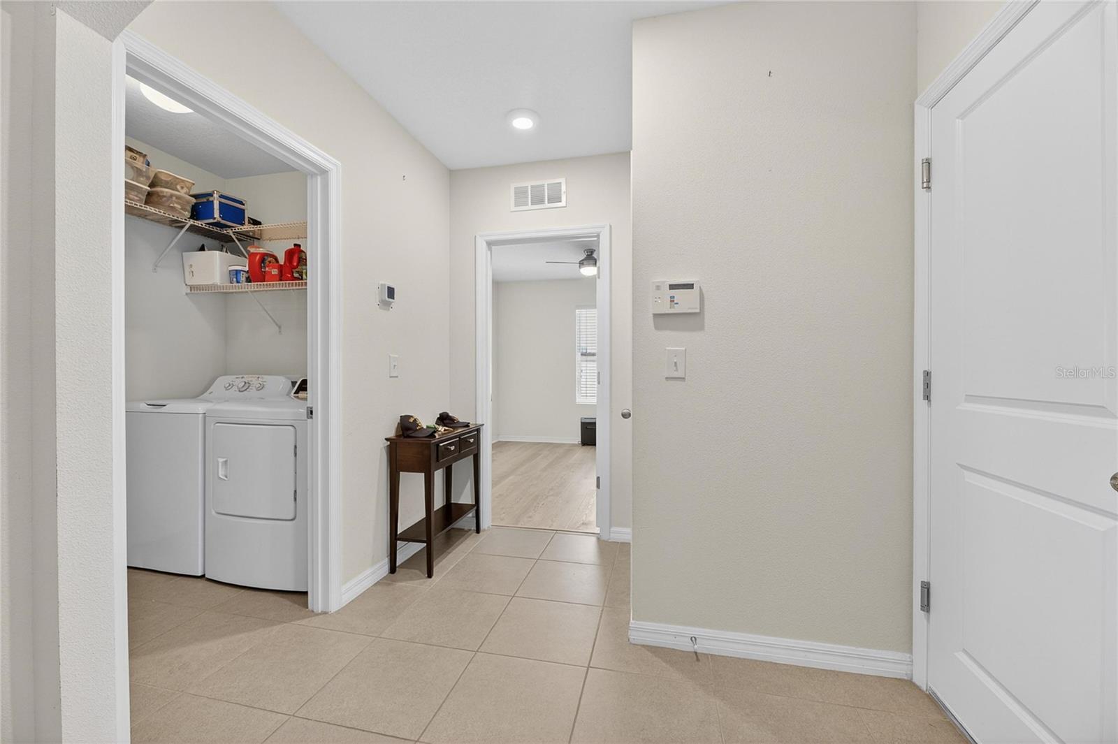 Indoor laundry room with newer washer and dryer