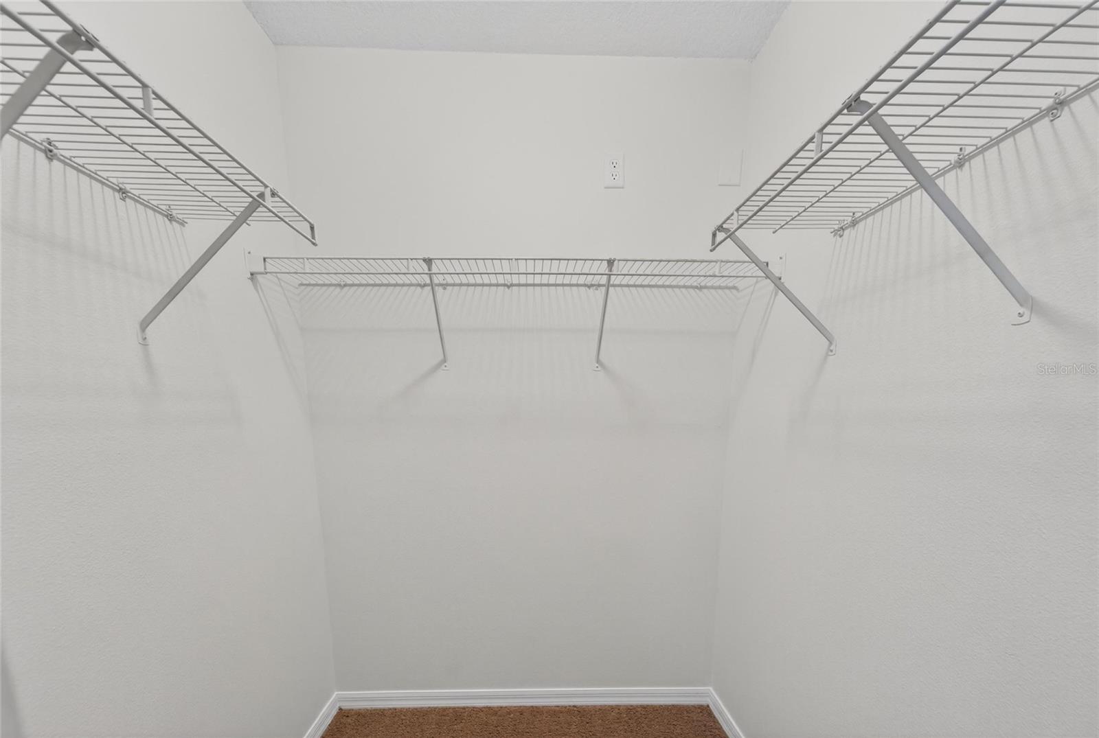 Walk in closet primary bedroom