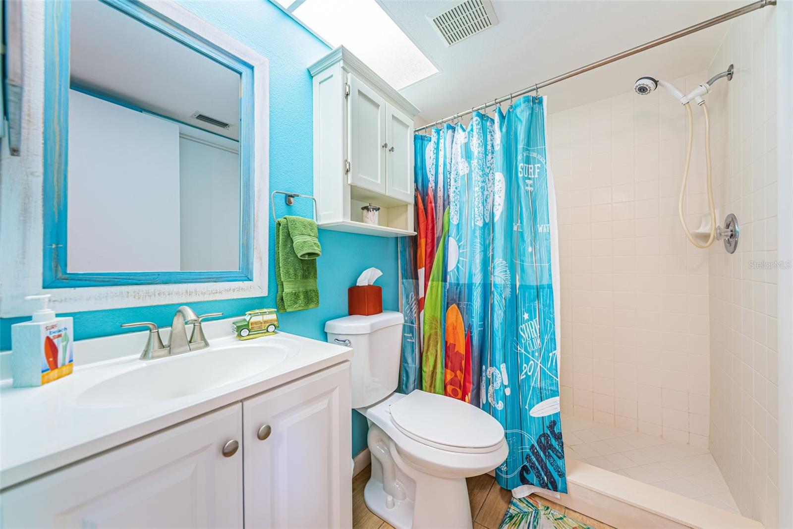 Second bathroom with walk-in shower and access to the second bedroom
