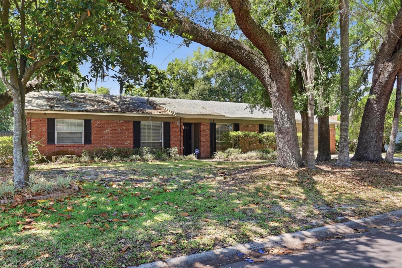 Beautiful brick with contrasting black window shutters and front covered entry