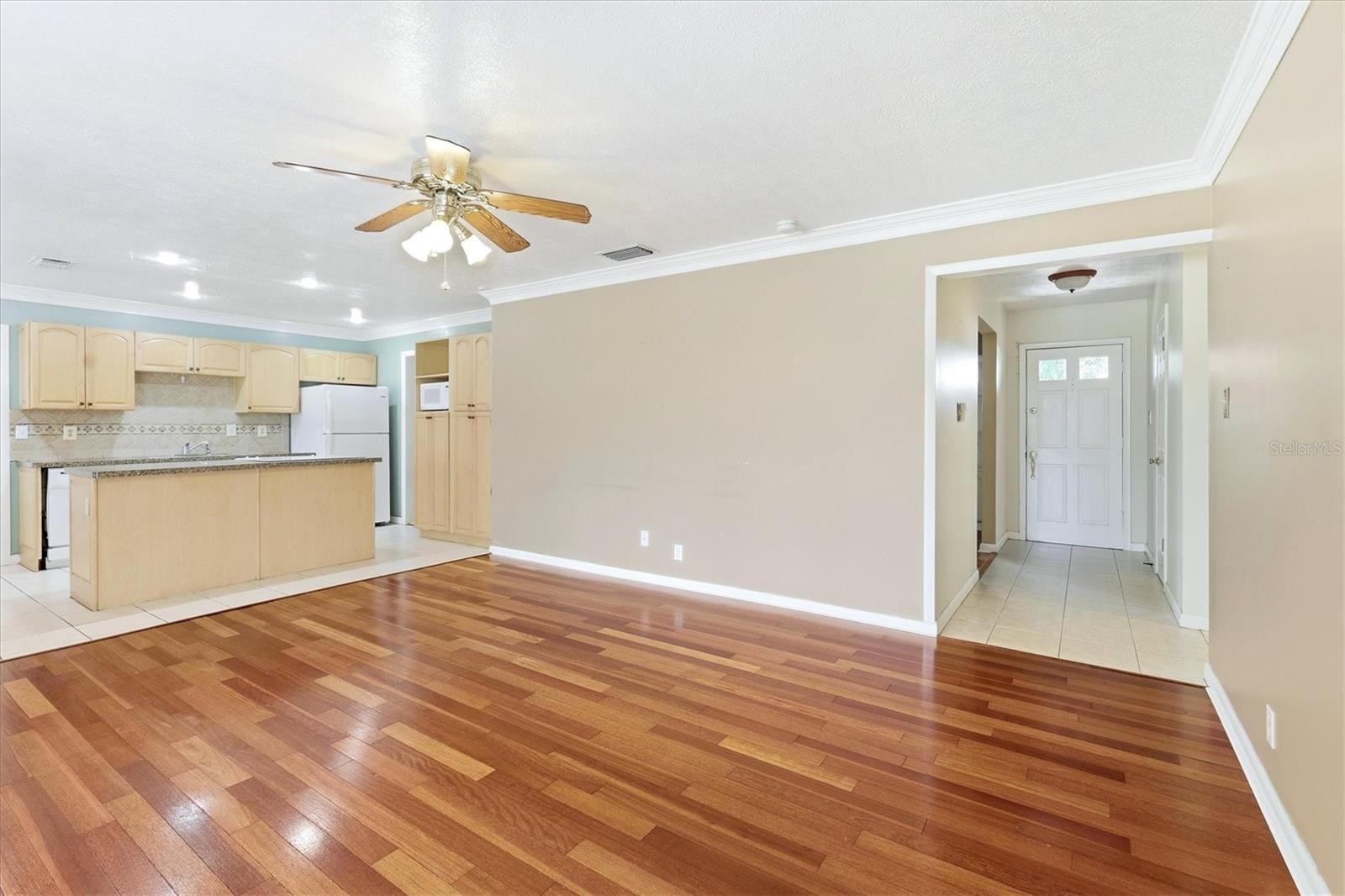4th bedroom/flex space features tile flooring and crown molding.  Overlooks backyard.