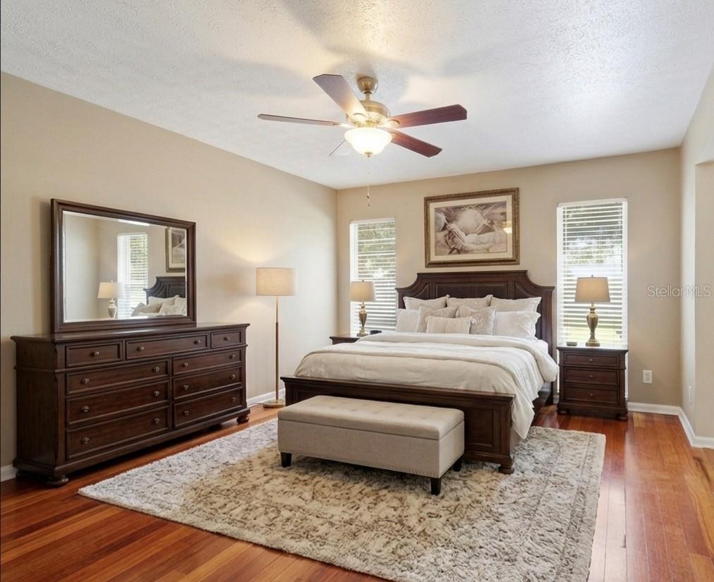 Primary bathroom features dual vanities with cabinets and drawers, a beauty bar and private bath with shower and toilet.