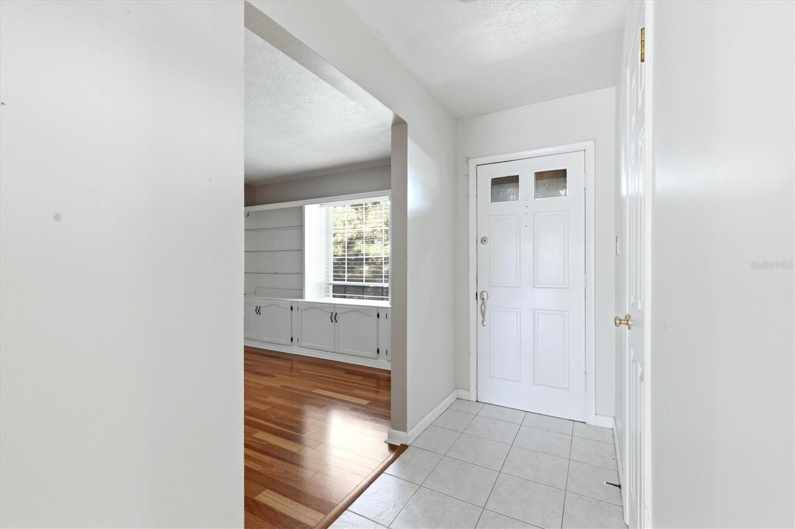 Foyer with coat closet is open to the living room and family room