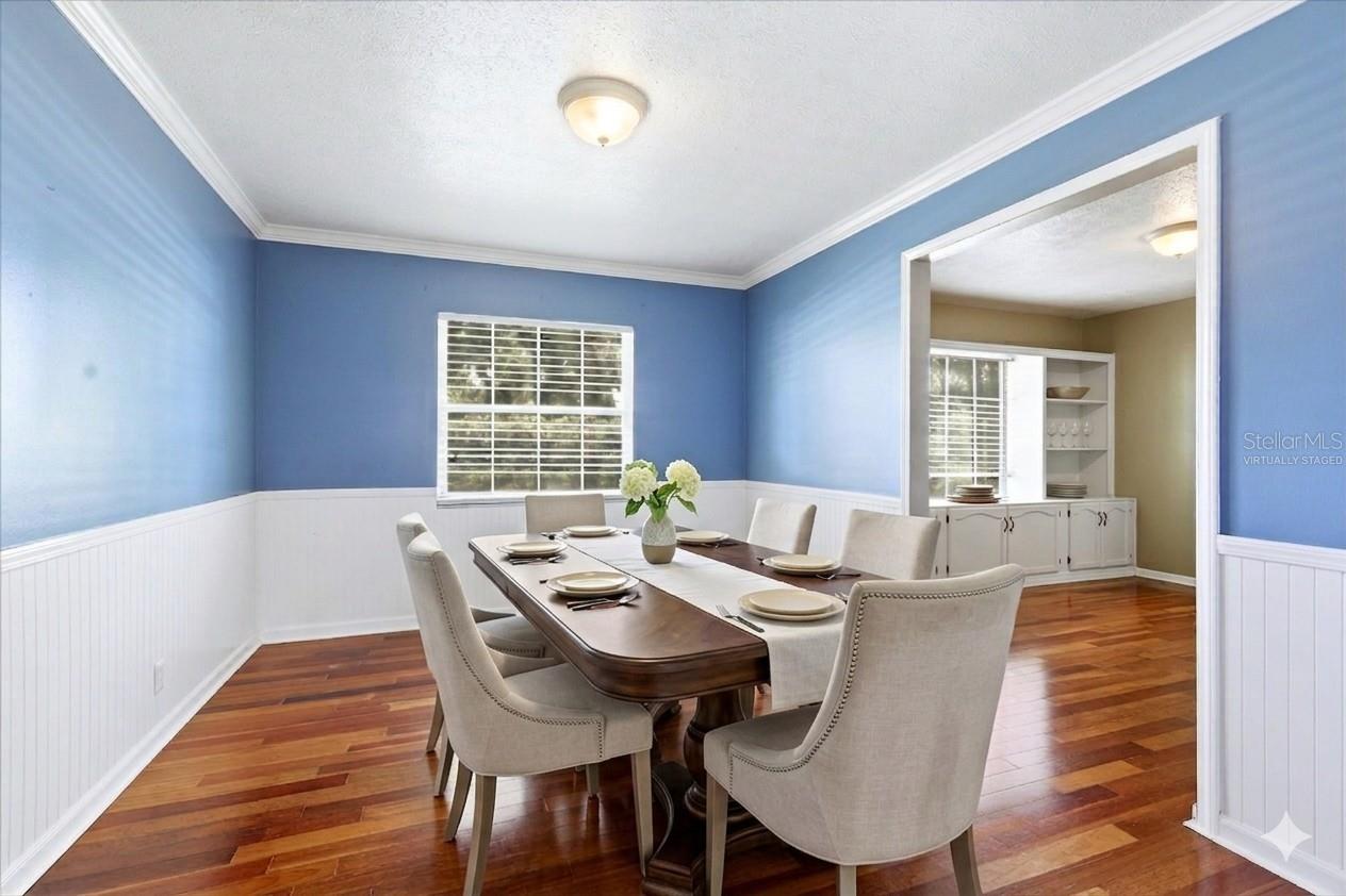 Dining Room offers decorative wainscoting and is adjacent to the living room and kitchen