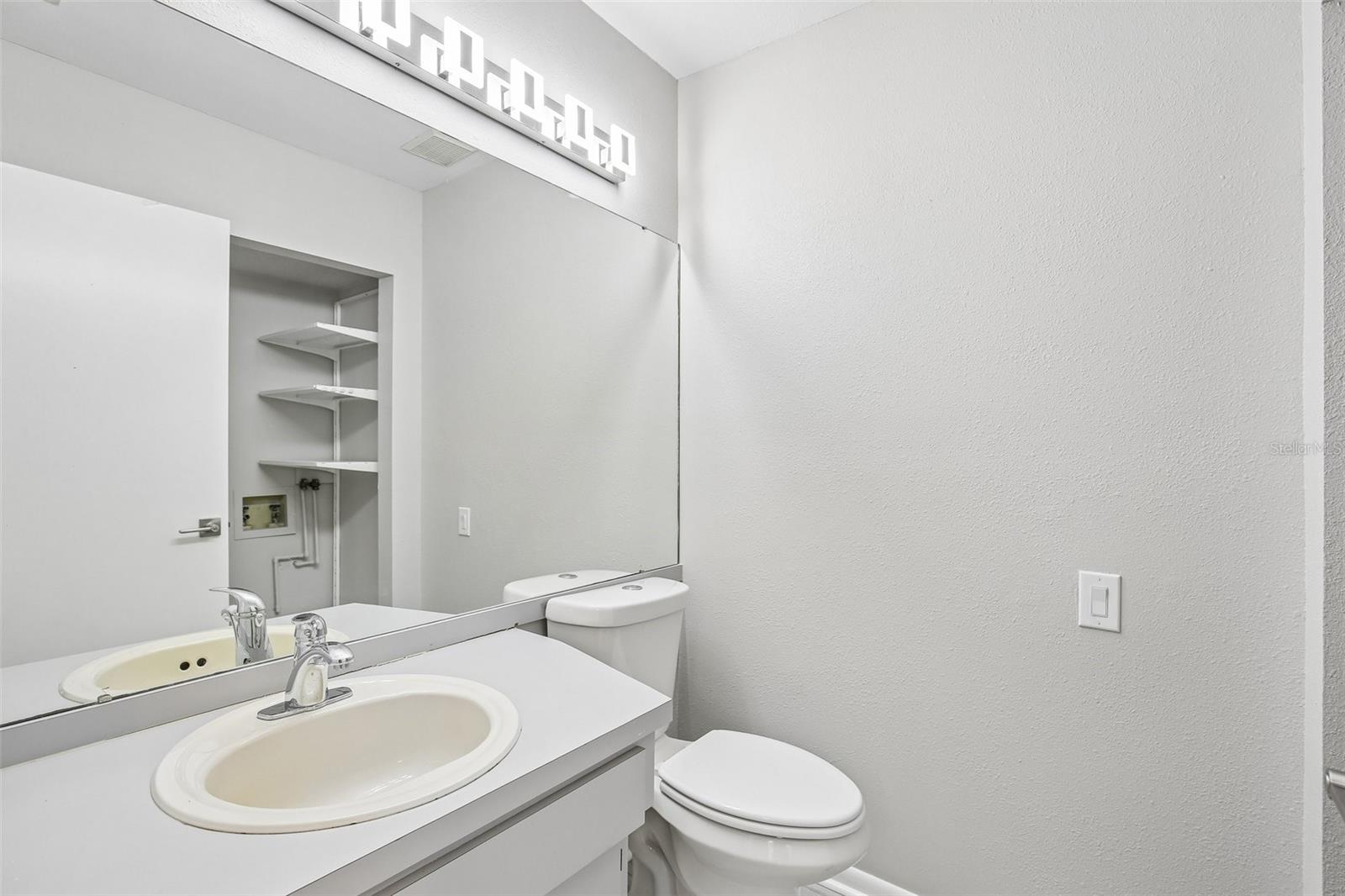 HALF BATH CONVENIENTLY LOCATED DOWNSTAIRS FOR GUEST USE