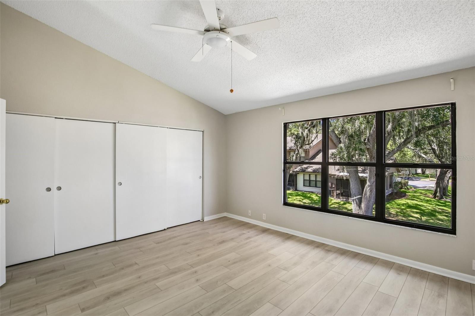 PRIMARY BEDROOM OVERLOOKS BACK YARD