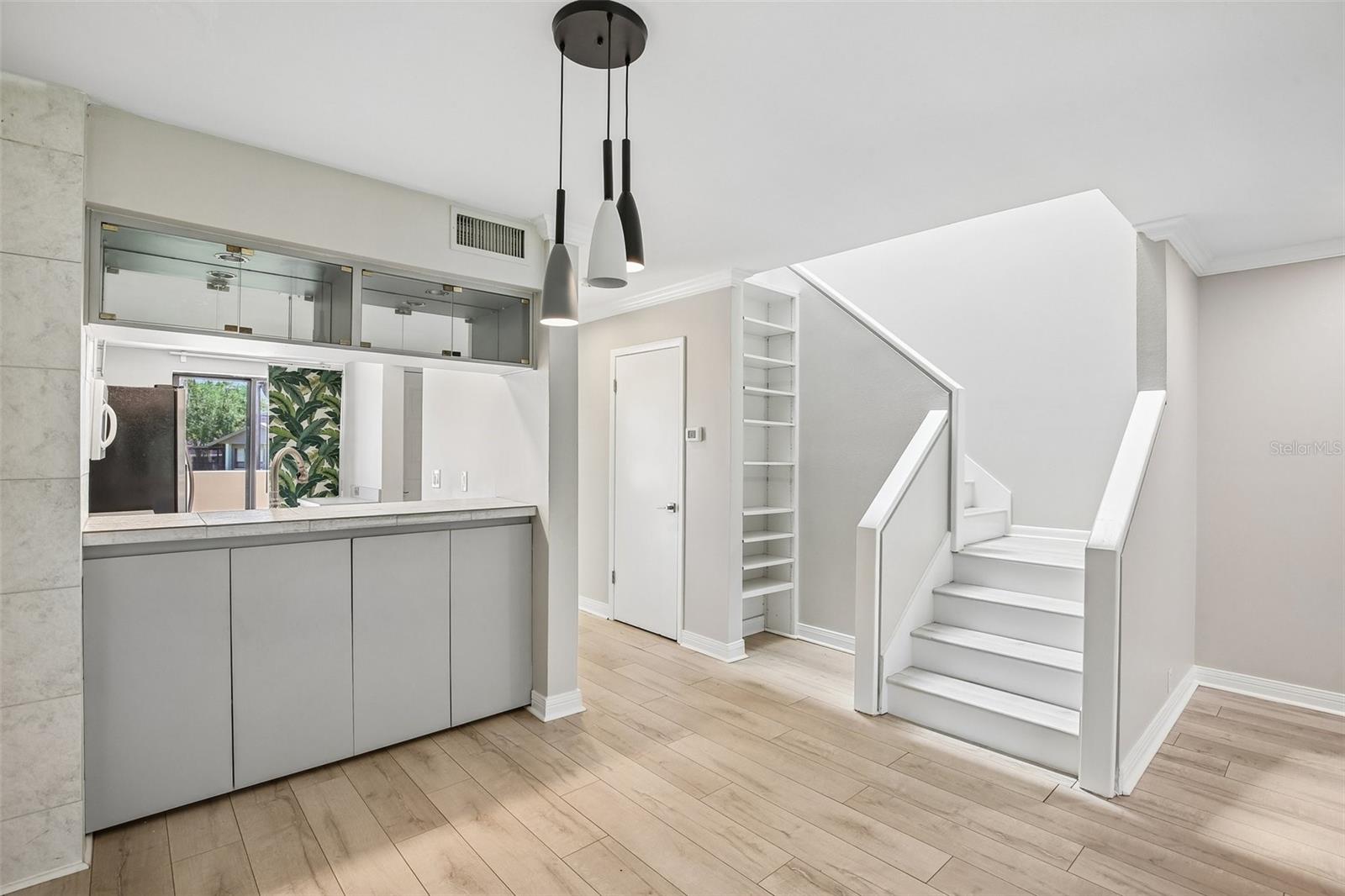 DINING ROOM WITH STAIRS LEADING TO ALL BEDROOM SUITES UPSTAIRS