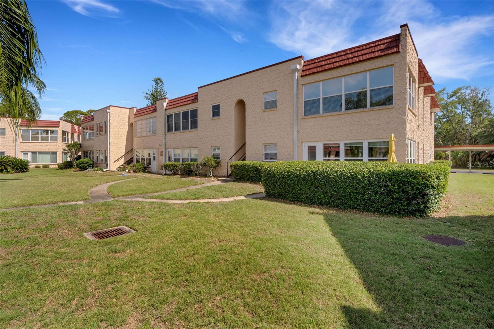 Back of Building With Stairway to Pool and Clubhouse Walkway