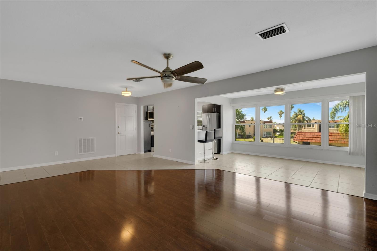 Living Room Looking to Florida Room and Kitchen. Pedestrian Door on Left Leads to Stairway Down to Pool and Clubhouse.