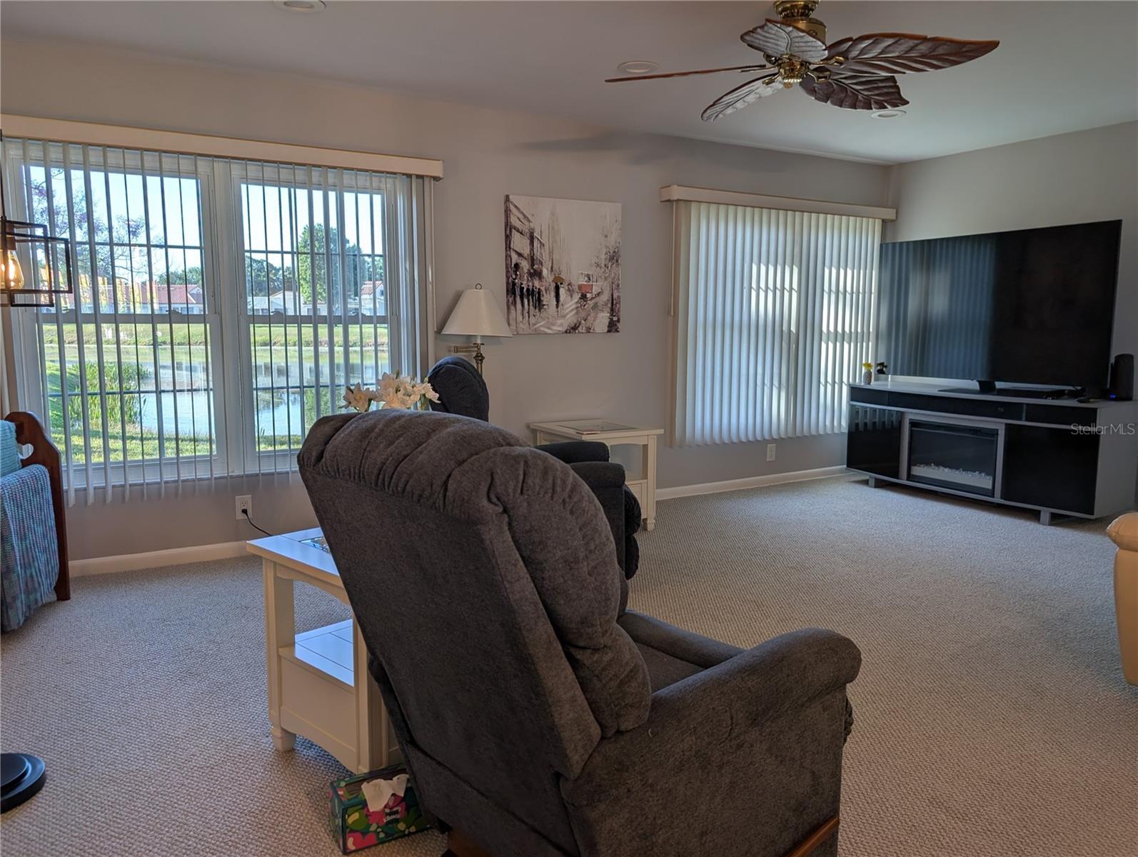 View from dining room into Florida room and the two large windows providing the natural light, natural air conditioning and the VIEW!