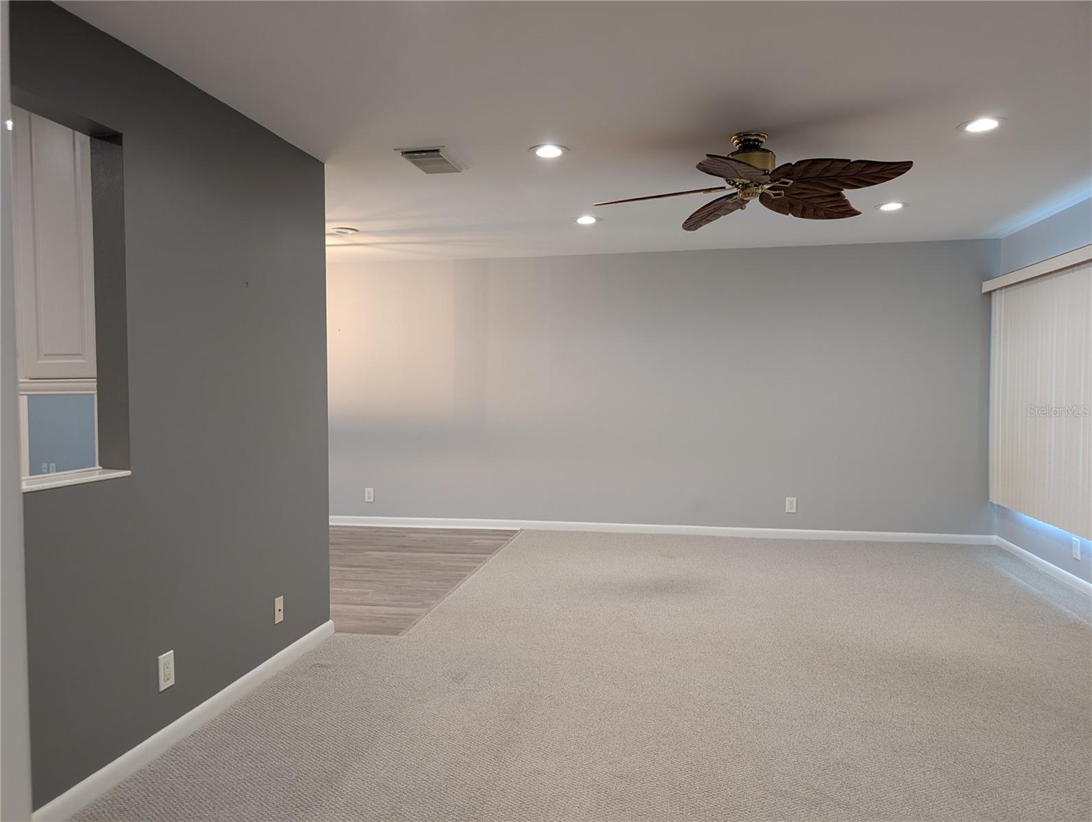 Family room with view of pass thru window to kitchen and dining room on left.
