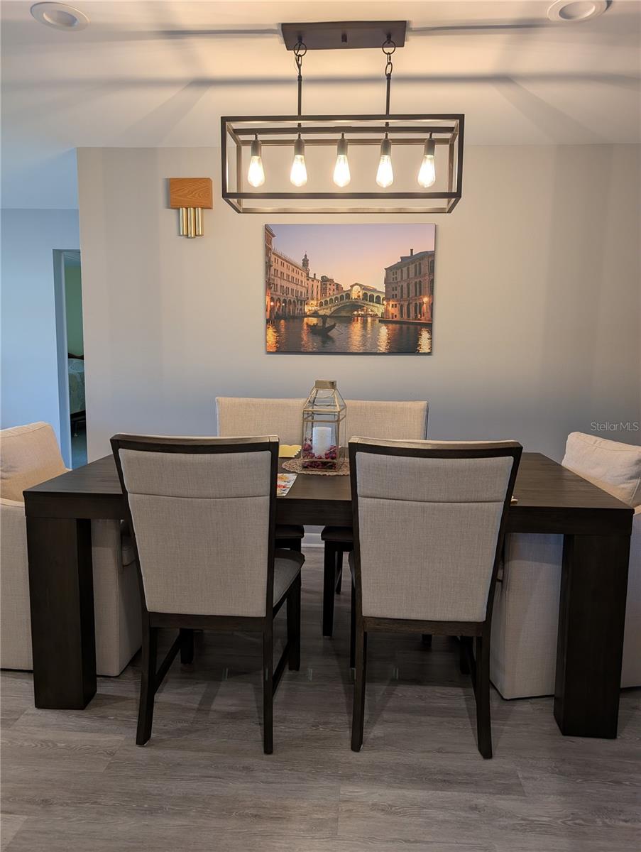 Recessed lighting showcases the stunning, sleek hanging light.
