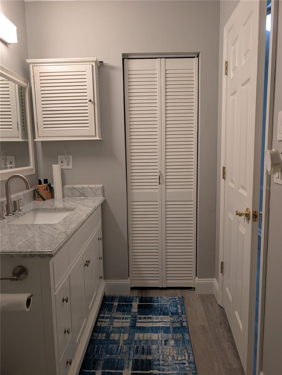 View from shower to linen closet.   Bedroom entrance to right.