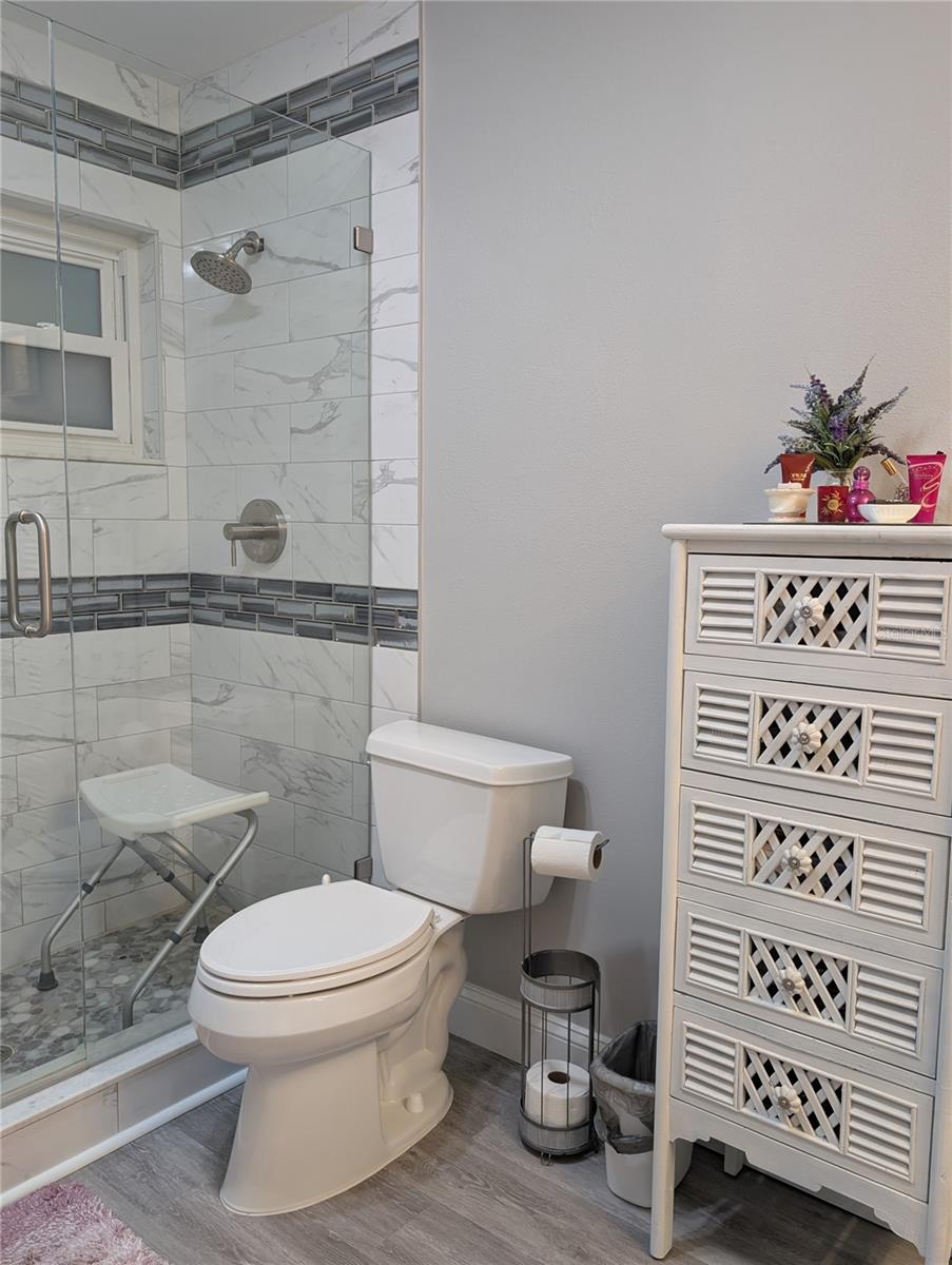 Primary bath updates include comfort height commode and stunning walk in shower.