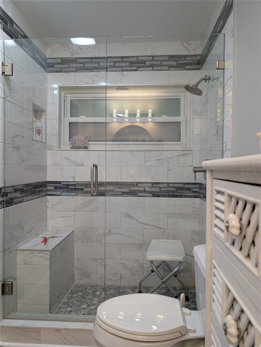 Gorgeous, tiled shower has window for more ventilation and light.