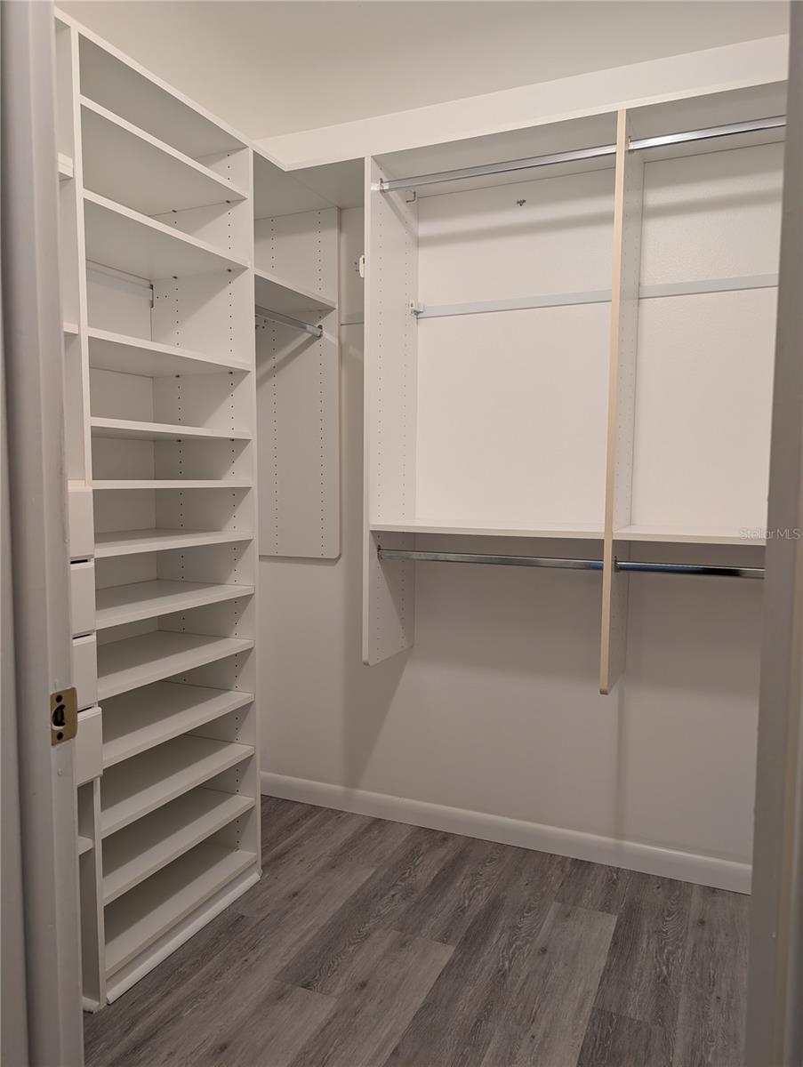 Master bedroom closet features California style organization with some special extras.