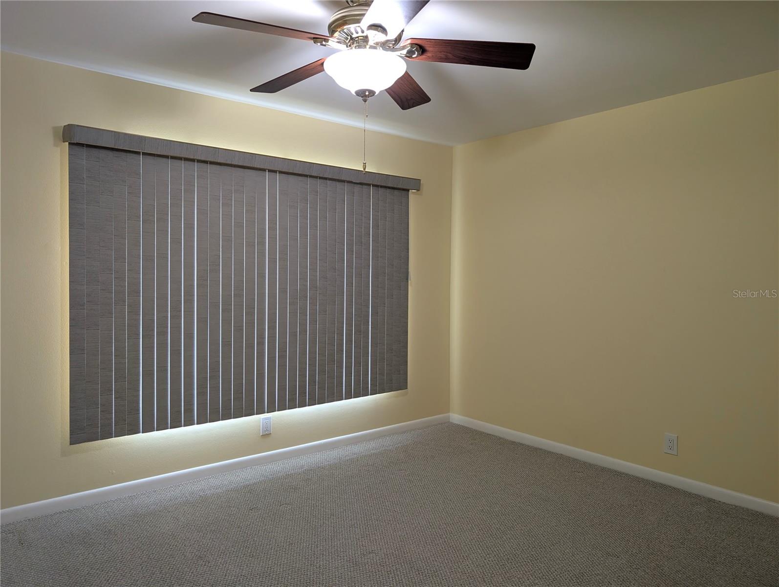 Spacious guest bedroom can comfortably accommodate a queen and king bed depending on the size of the dressers.