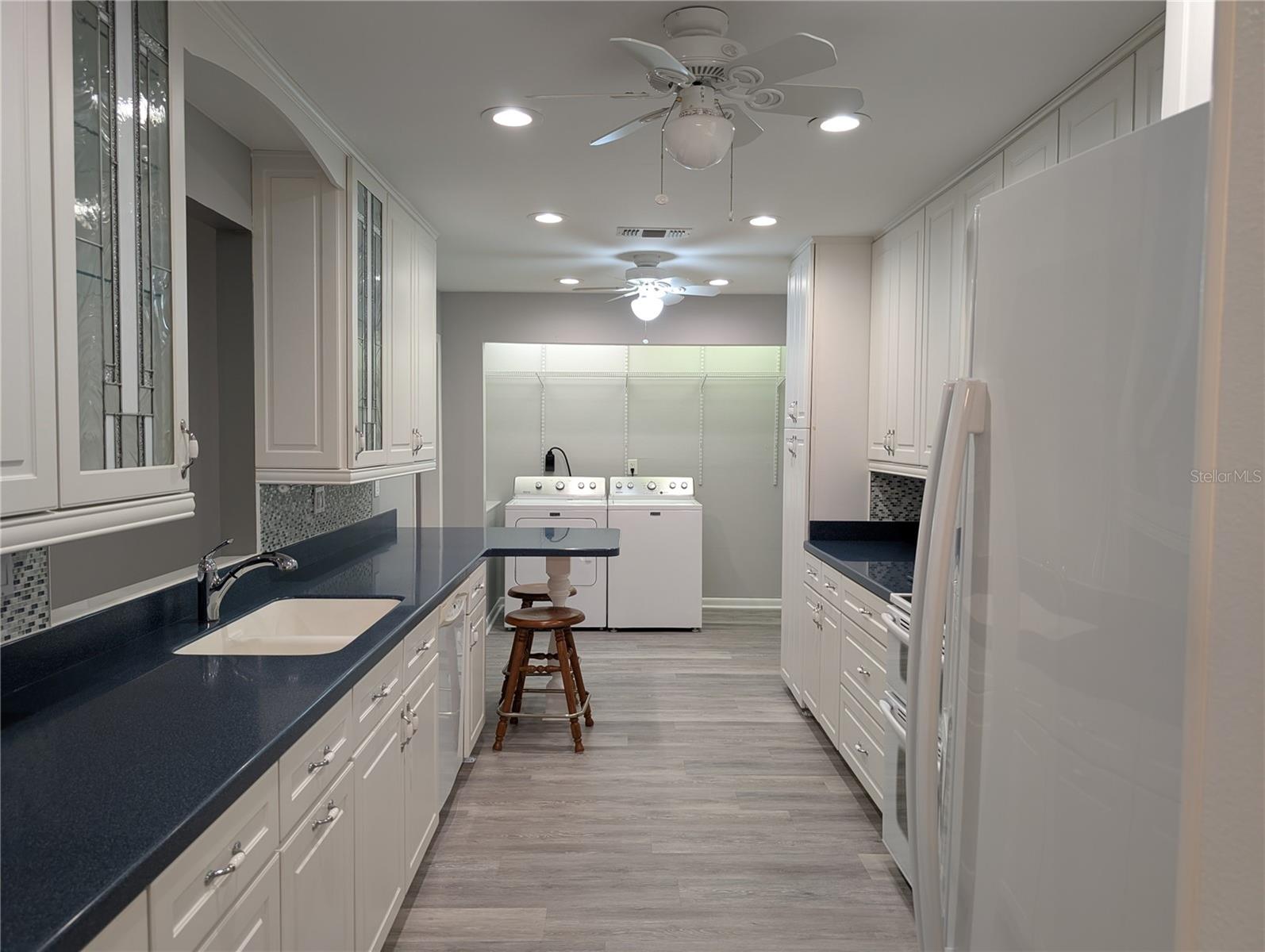 Full kitchen view from Dining room to interior laundry for the WHOLE effect. A "gormay" kitchen that won't disappoint. Kraftmaid cabinets feature 42" cabinets, soft close drawers and pull-out shelves in pantry. New kitchen design provides better workspace and extra storage...a dream kitchen.