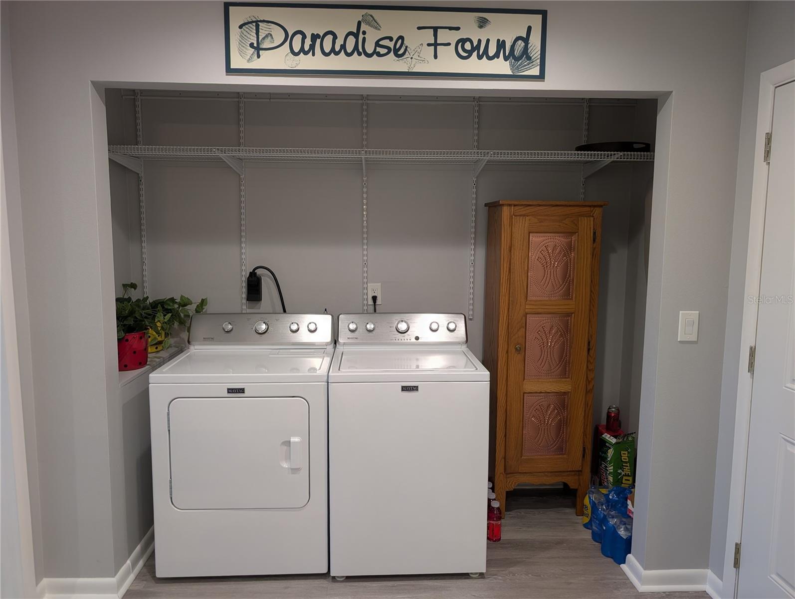 Interior laundry features extra storage and Maytag Commercial Technology washer & dryer. Access to bonus room is left & garage is to right of laundry.