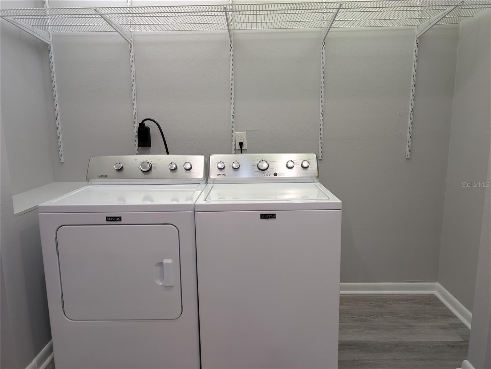 View of laundry area with storage.