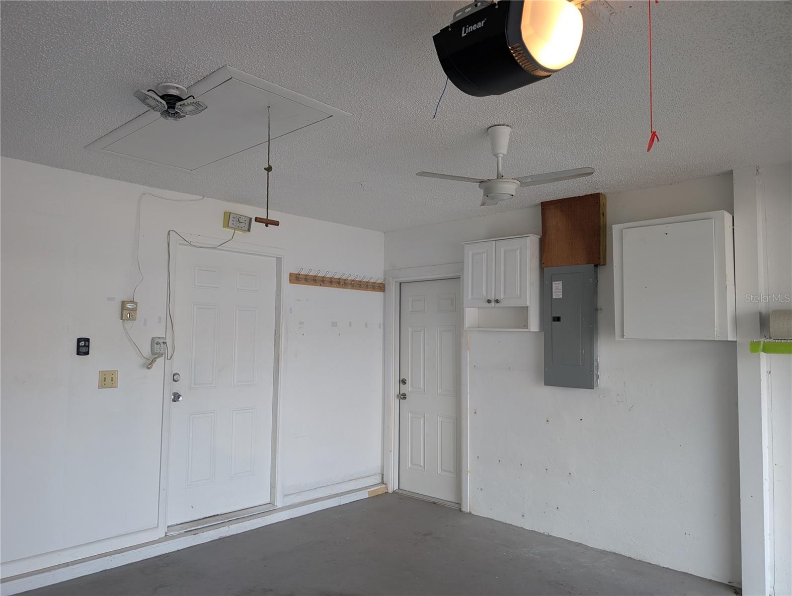 Garage features include updated Eaton Electric Panel, pull down attic access, 6 panel interior access doors to sideyard and kitchen, Linear garage door motor (2019).