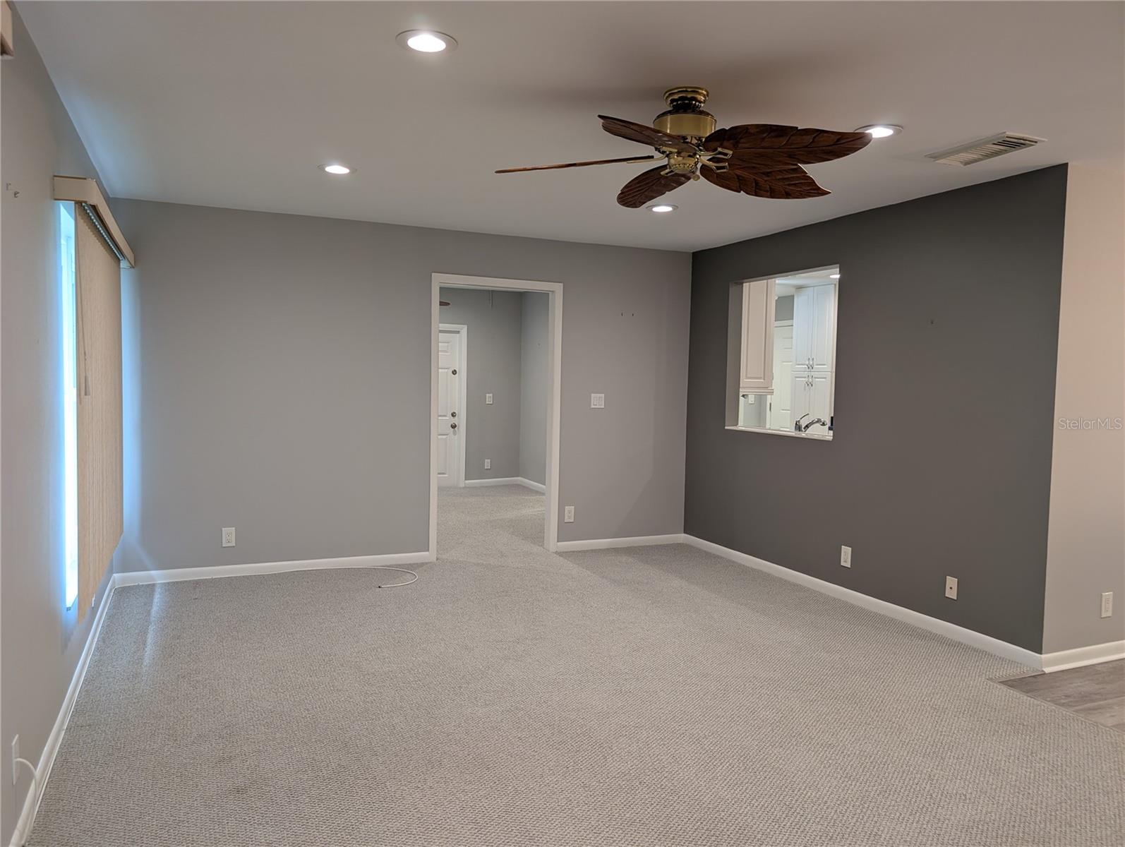 View of Florida room into Bonus room and pass thru window to kitchen.