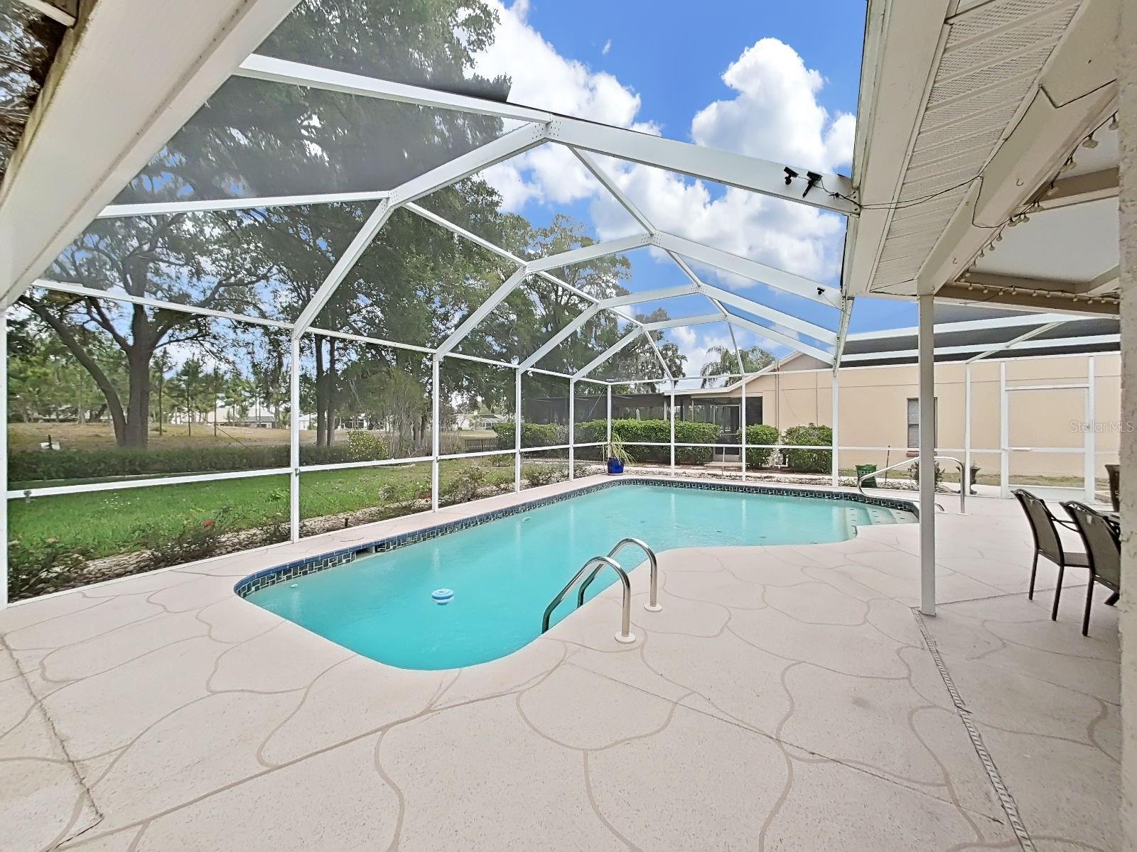 Totally screen enclosed, solar heated pool.