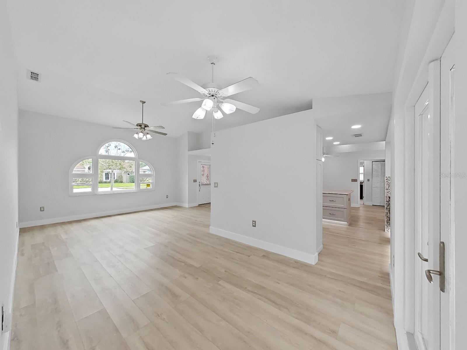 another view of living and dining rooms, a peak into the kitchen.
