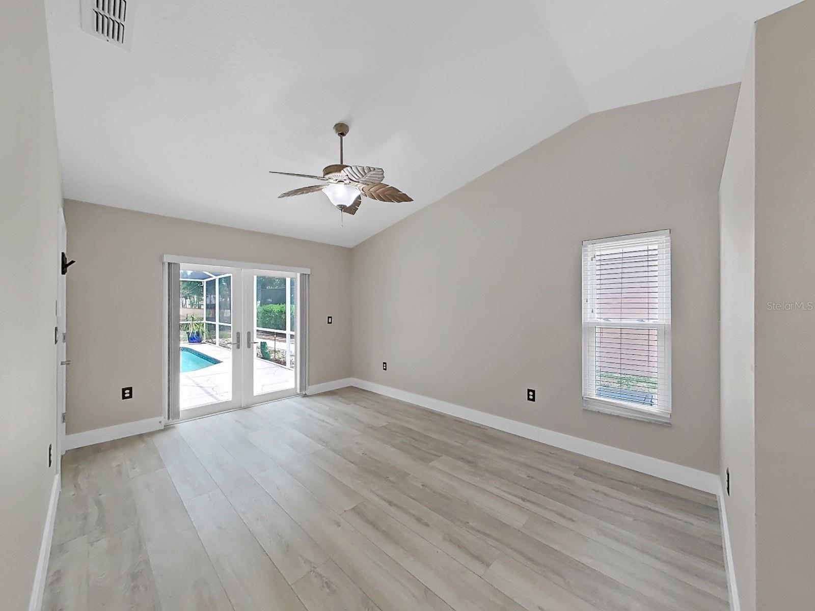 Primary suite with double doors out to the pool, gorgeous view.