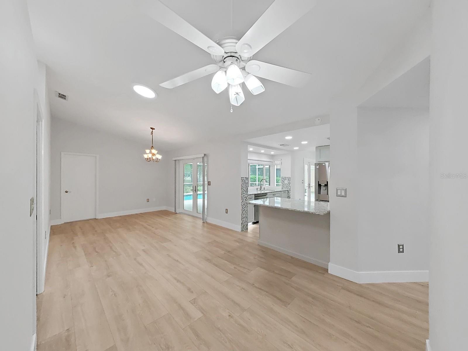 Formal dining room. Even a skylight. Another set of doors out to the pool. Pool bathroom is behind thatclosed door at rear of this picture.