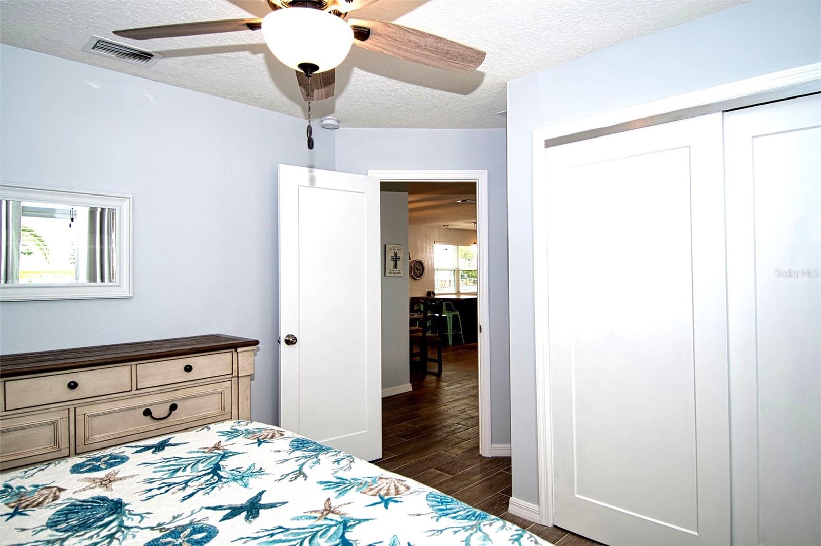 Guest bedroom has full wall of closet space.