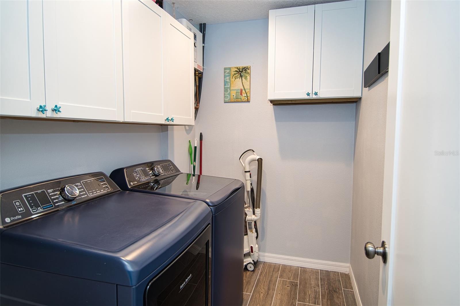 Spacious inside laundry utility room.  Plenty of overhead cabinet storage space for cleaning supplies.