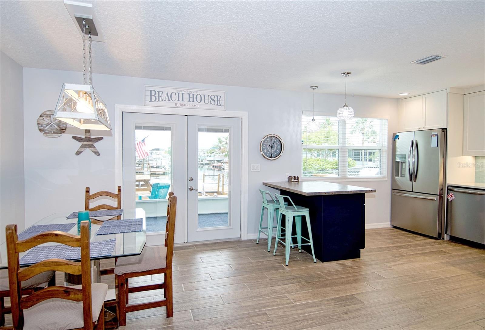 Attention to detail is evident with this easy care flooring throughout, neutral paint, striking kitchen offers dual color cabinetry featuring dark blue lowers with white uppers and coordinating back splash for that WOW factor!!