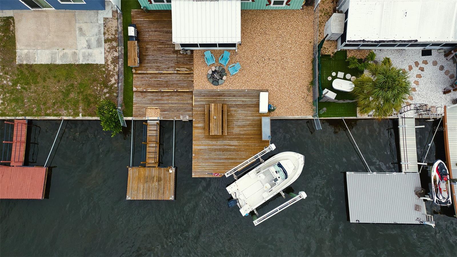 Overview of this easy care backyard space, docks and boat lift.