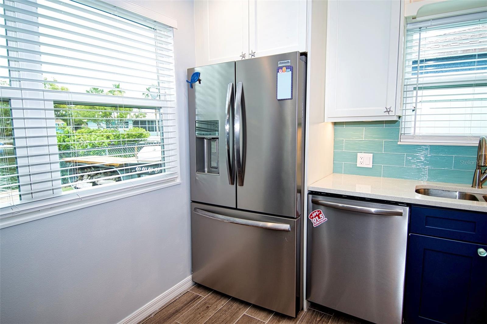 Large windows bring the outside in with view of canal and boats motoring out to Gulf waters.
