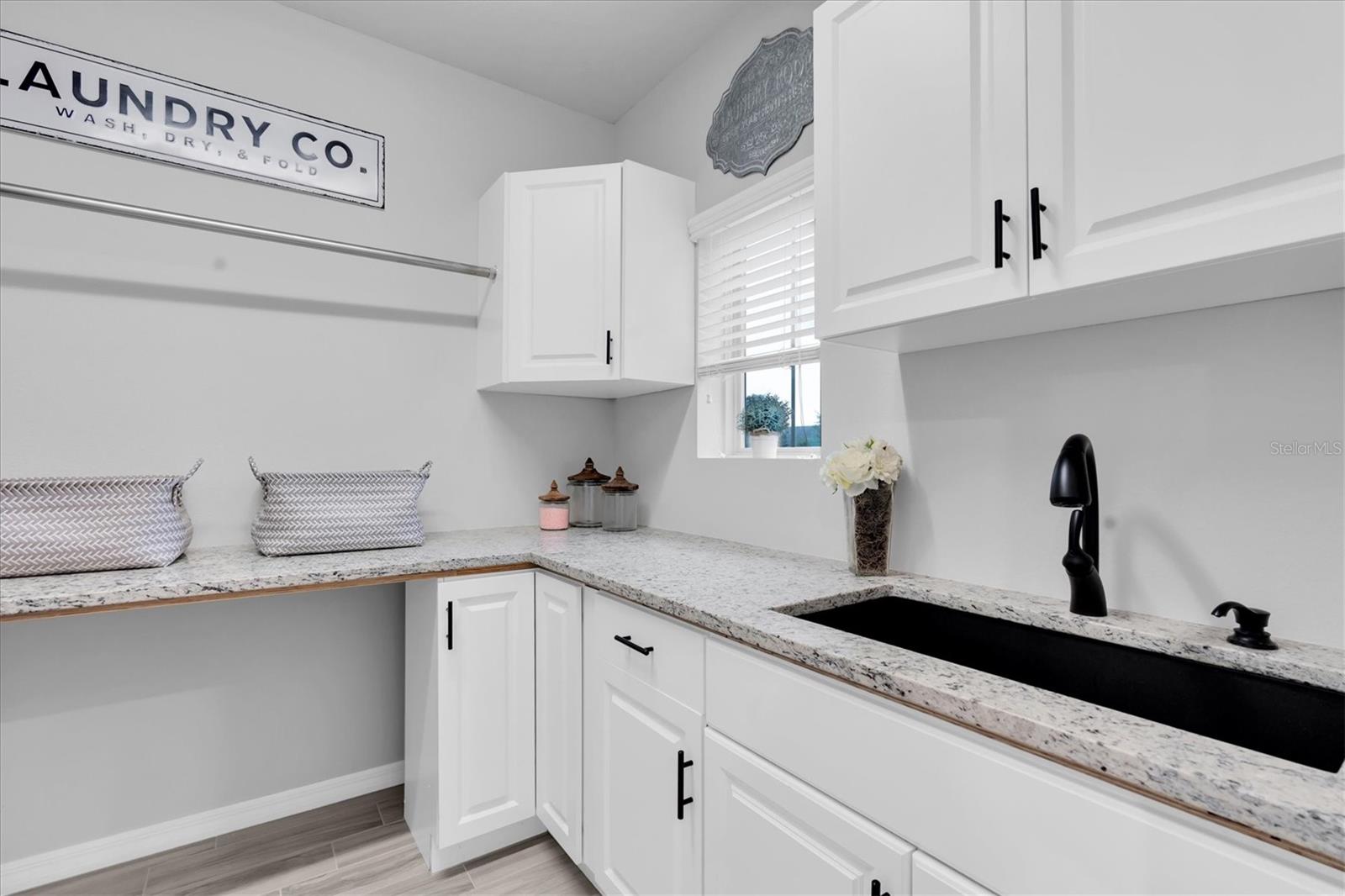 Laundry w/ sink & built-in cabinets
