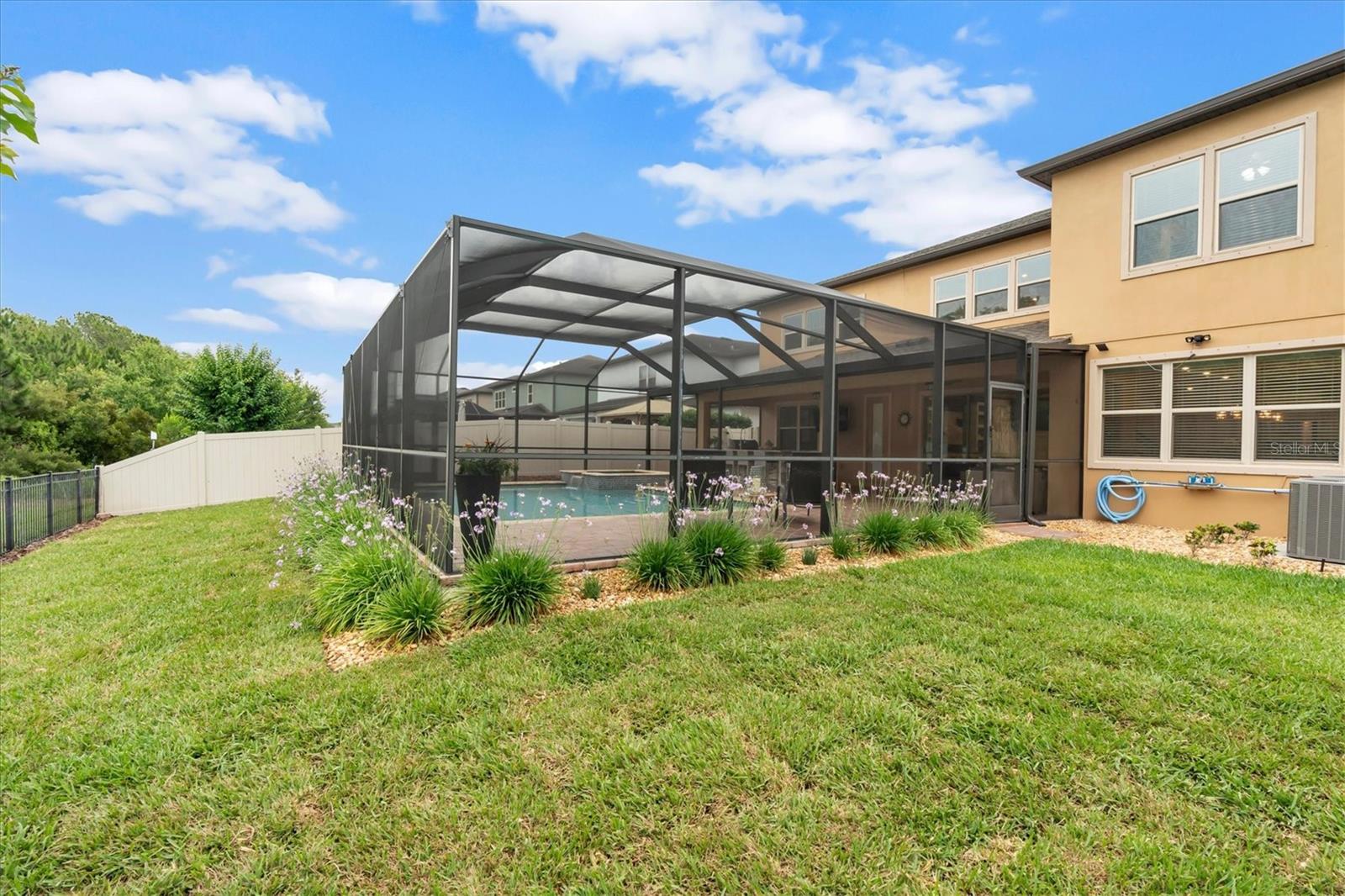 Backyard w/ pool & screen enclosure