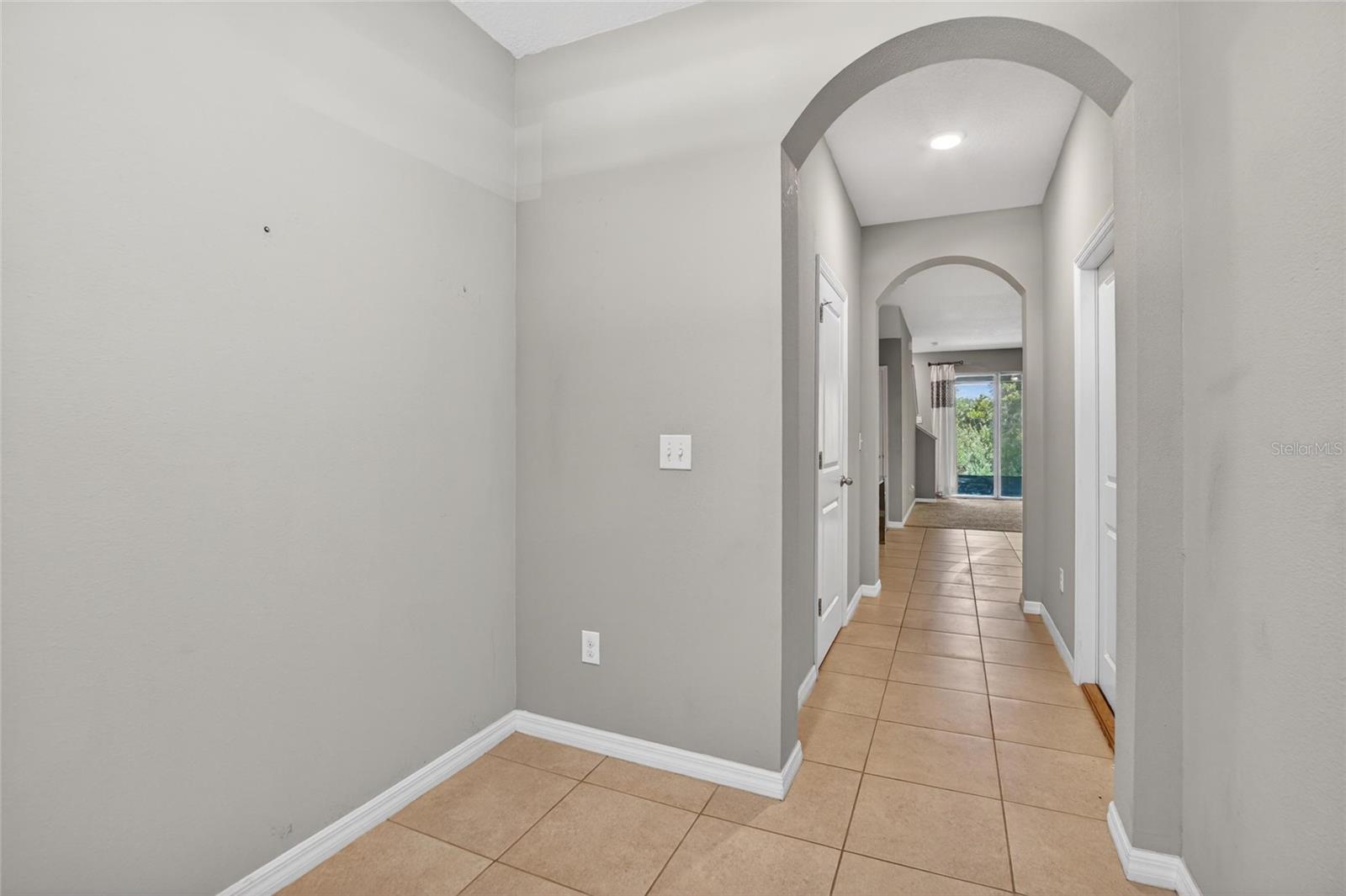 GARAGE DOOR TO THE RIGHT AND HALF BATH TO THE LEFT