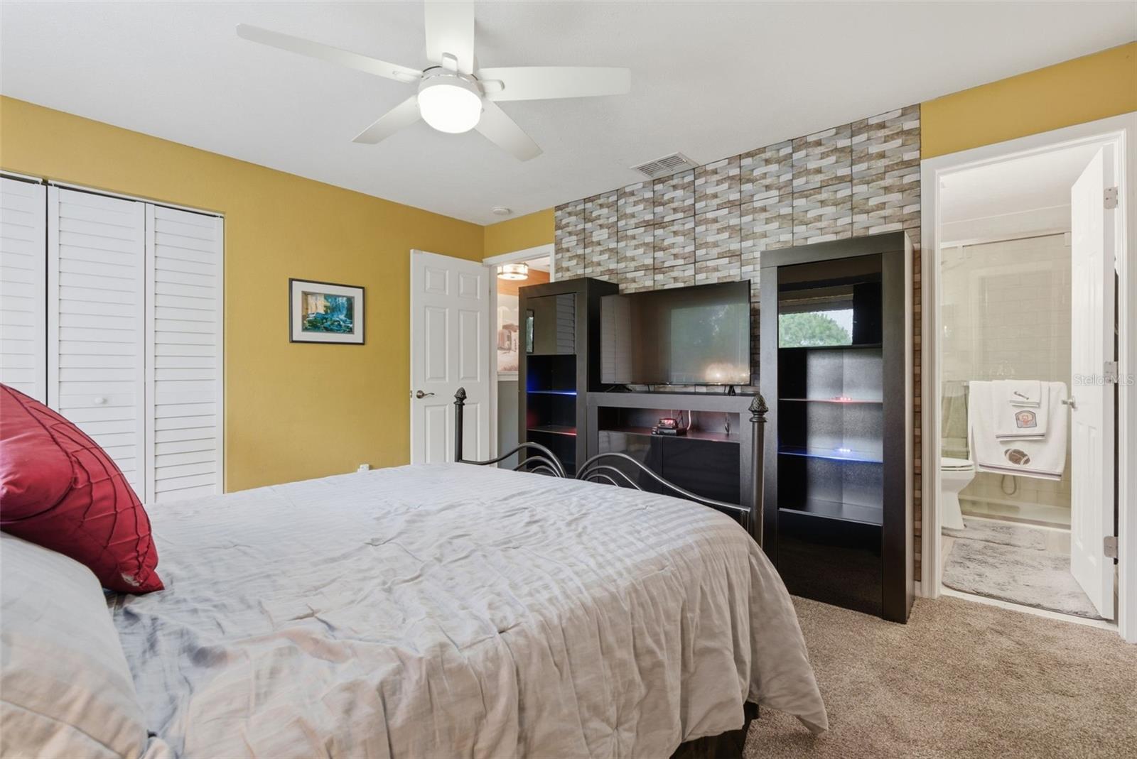 A second feature wall in the bedroom adds texture, depth, and an upgraded designer feel to the space.