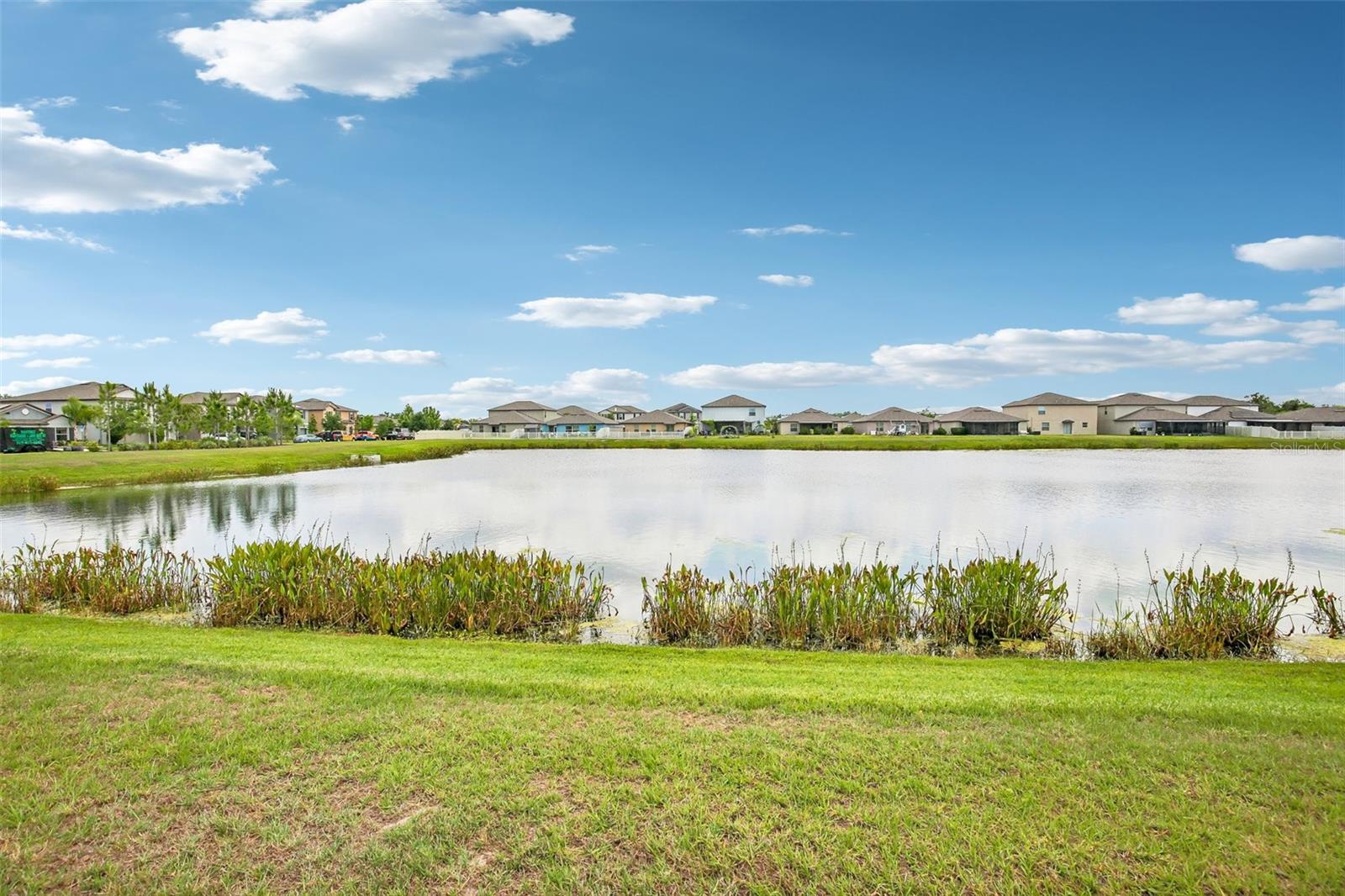FENCED YARD HAS TRANQUIL POND VIEW