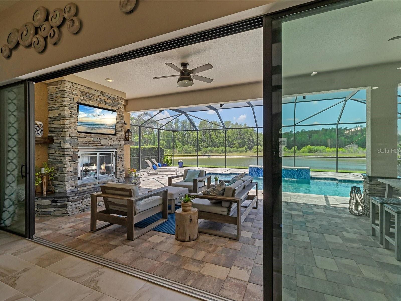 16ft sliding glass doors opening to the outdoor oasis